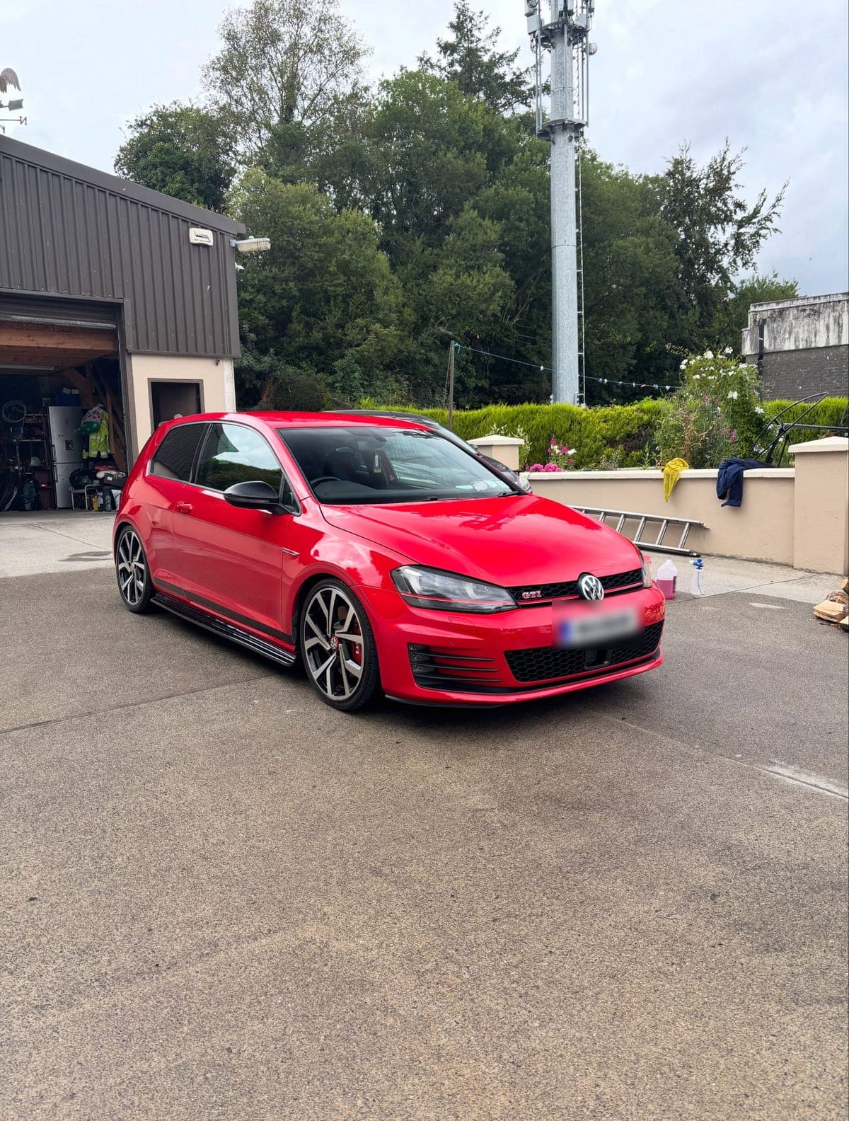 Red Volkswagen Golf GTI with glossy paintwork after a clean